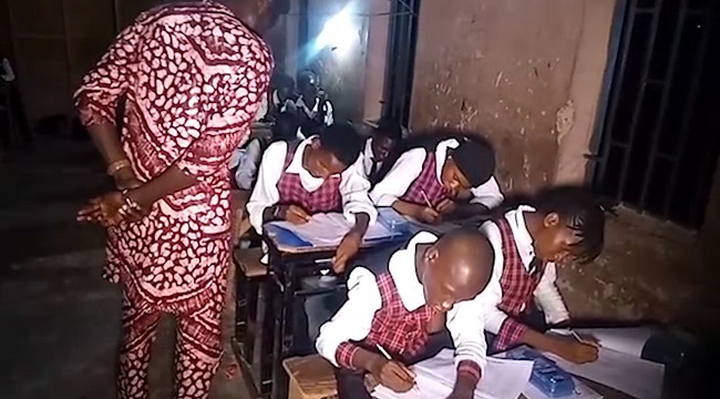 Students writing WAEC exam at night in Taraba State.